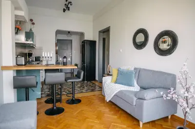 a living room with a couch and a kitchen at Erato by Heloni Apartments in Athens