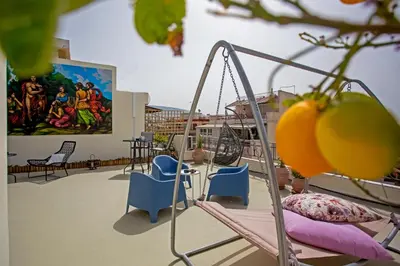 a room with chairs and a painting on the wall at Erato by Heloni Apartments in Athens