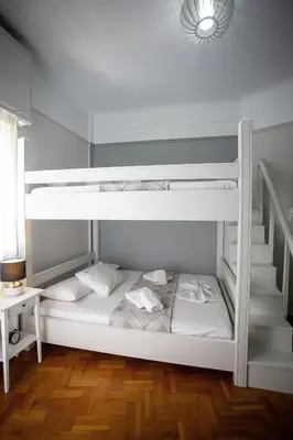a white bunk bed in a room with a staircase at Erato by Heloni Apartments in Athens