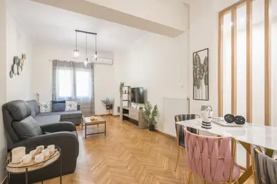a living room with a couch and a table at Elegant Suite by CloudKeys in Athens