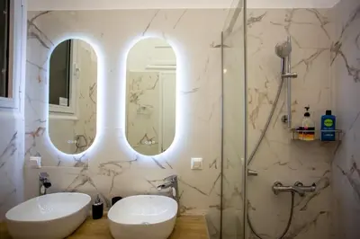 a bathroom with two sinks and a shower at Ourania by Heloni Apartments in Athens