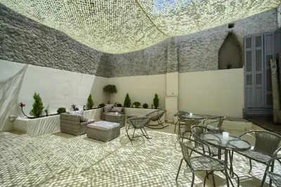 a living room with chairs and tables and a couch at Karma Athens in Athens