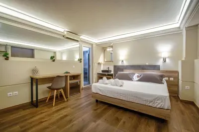 a bedroom with a large bed and a desk and a desk at Karma Athens in Athens