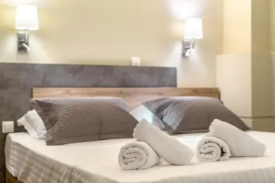 a bedroom with a bed with towels on it at Karma Athens in Athens