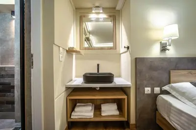 a bathroom with a sink and a bed at Karma Athens in Athens