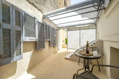 an empty balcony with a table and a window at Karma Athens in Athens