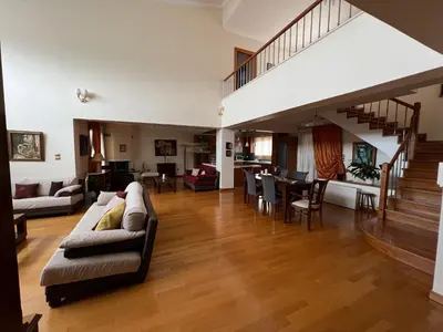 a living room with a couch and a dining room at Seaside Villa Lagonisi in Kalívia Thorikoú