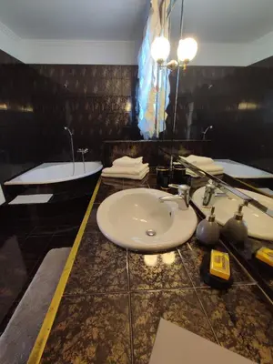 a bathroom with a sink and a bath tub at Seaside Villa Lagonisi in Kalívia Thorikoú