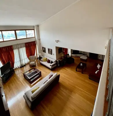 an overhead view of a living room with wood floors at Seaside Villa Lagonisi in Kalívia Thorikoú