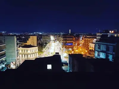 a view of a city at night with buildings at Acropol Studio Loft with amazing view & terrace in Athens