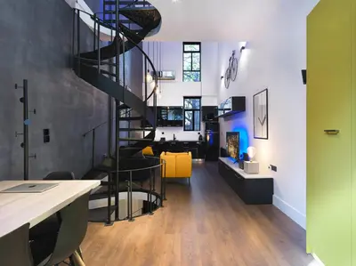 a spiral staircase in a room with a living room at 200 Mb fibre remote workers' Dreamhouse in Athens