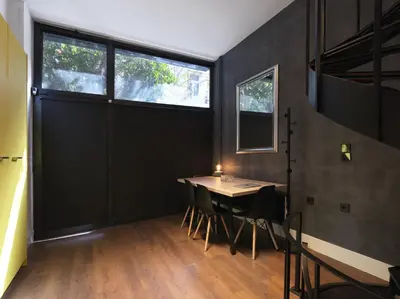 a dining room with a table and some windows at 200 Mb fibre remote workers' Dreamhouse in Athens