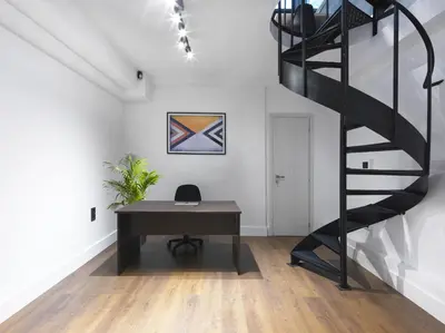 an office with a desk and a spiral staircase at 200 Mb fibre remote workers' Dreamhouse in Athens