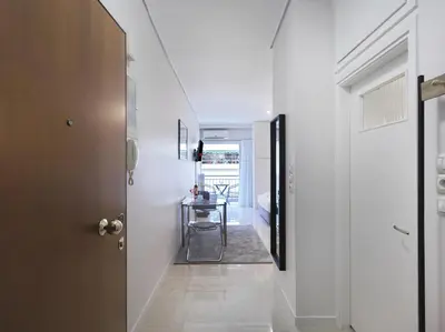 a hallway with a door and a table in a room at Modern Studio opposite the Areios Pagos court. in Athens