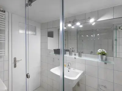 a bathroom with a sink and a shower with a mirror at Modern Studio opposite the Areios Pagos court. in Athens