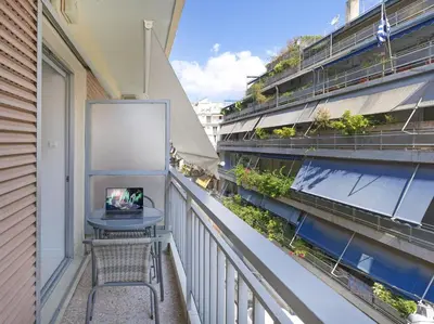a balcony with a table and a laptop on it at Modern Studio opposite the Areios Pagos court. in Athens