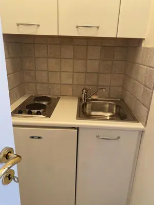 a kitchen with a sink and a stove at PortoRafti seaview garden Villa in Porto Rafti