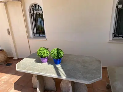 two potted plants sitting on a table in a room at PortoRafti seaview garden Villa in Porto Rafti