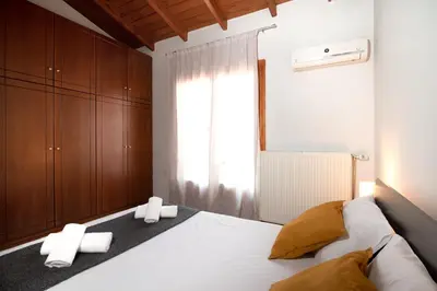 a bedroom with a bed with two towels on it at markopoulo-apartmets in Markopoulo