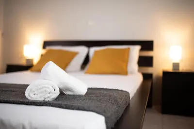 a hotel room with a bed with towels on it at markopoulo-apartmets in Markopoulo