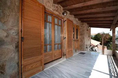 an entrance to a house with wooden doors at markopoulo-apartmets in Markopoulo