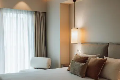 a bedroom with a bed and a chair and a window at The Residence Aiolou Hotel & Spa in Athens