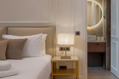 a bedroom with a bed and a table with a lamp at The Residence Aiolou Hotel & Spa in Athens