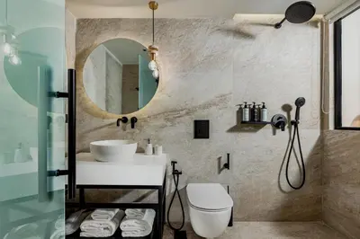 a bathroom with a sink and a mirror at The Residence Aiolou Hotel & Spa in Athens