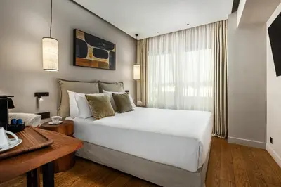 a bedroom with a large white bed and a window at The Residence Aiolou Hotel & Spa in Athens