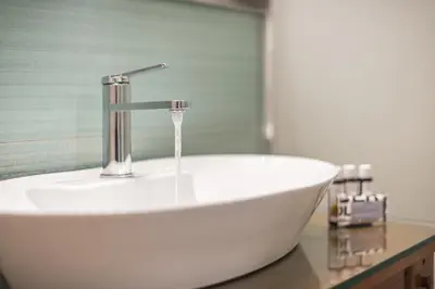 a white sink with a faucet in a bathroom at Stylish Luxury Apartment at Ampelokipi Metro station in Athens