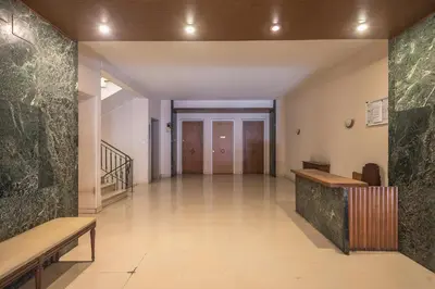 an empty hallway with benches and a staircase in a building at Stylish Luxury Apartment at Ampelokipi Metro station in Athens