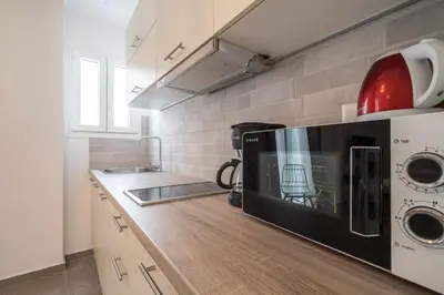 a kitchen with a microwave oven and a counter top at Athens Gift, only 300m from Acropolis Museum in Athens