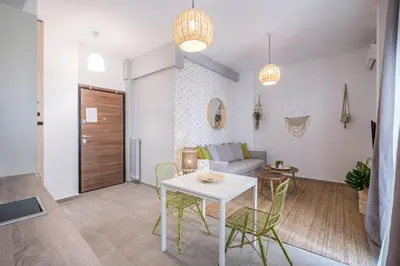 a living room with a white table and chairs at Athens Gift, only 300m from Acropolis Museum in Athens