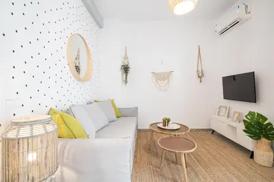 a white living room with a couch and a table at Athens Gift, only 300m from Acropolis Museum in Athens