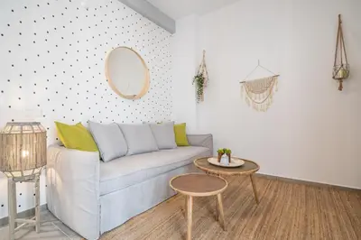 a living room with a couch and a table at Athens Gift, only 300m from Acropolis Museum in Athens