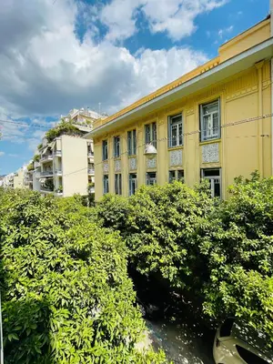 a yellow building with bushes in front of it at 1 BedRoom Apt - Live Like A Local In Kolonaki in Athens
