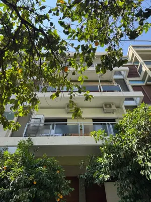 an apartment building with balconies and trees at 1 BedRoom Apt - Live Like A Local In Kolonaki in Athens