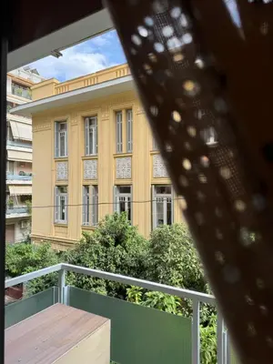 a view of a yellow building from a balcony at 1 BedRoom Apt - Live Like A Local In Kolonaki in Athens