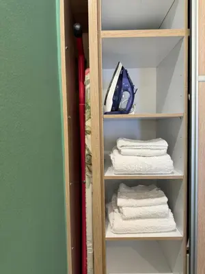 a closet with white towels on a shelf at 1 BedRoom Apt - Live Like A Local In Kolonaki in Athens