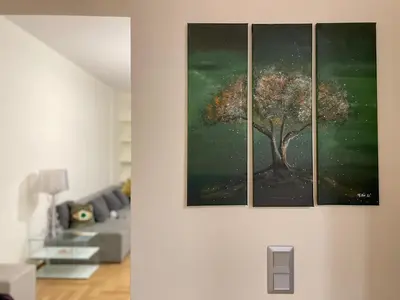 a living room with three paintings on the wall at 1 BedRoom Apt - Live Like A Local In Kolonaki in Athens