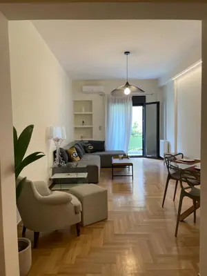 a living room with a couch and a table at 1 BedRoom Apt - Live Like A Local In Kolonaki in Athens