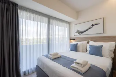 a bedroom with a large bed with towels on it at Hestia - Alexandras 38 in Athens
