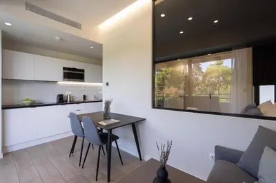 a kitchen and living room with a table and chairs at Hestia - Alexandras 38 in Athens