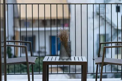 two chairs and a table with a vase on it at Hestia - Alexandras 38 in Athens