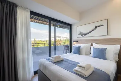 a bedroom with a large bed and a large window at Hestia - Alexandras 38 in Athens