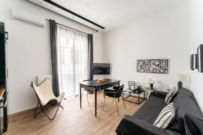 a living room with a couch and a table at Neo Luxury Suite in Athens