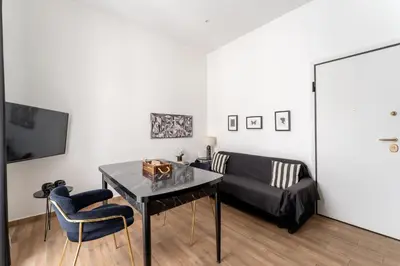 a living room with a black couch and a table at Neo Luxury Suite in Athens