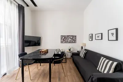 a living room with a black couch and a table at Neo Luxury Suite in Athens