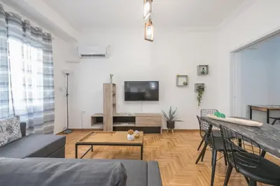 a living room with a couch and a table at Athens Bright Suite by CloudKeys in Athens