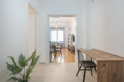 a kitchen and dining room with a table and chairs at Athens Bright Suite by CloudKeys in Athens